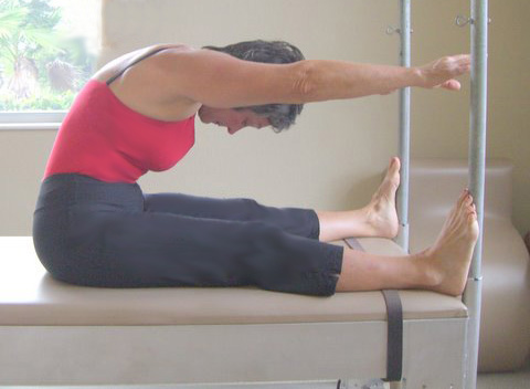 Spine stretch forward on pilates Cadillac equipment