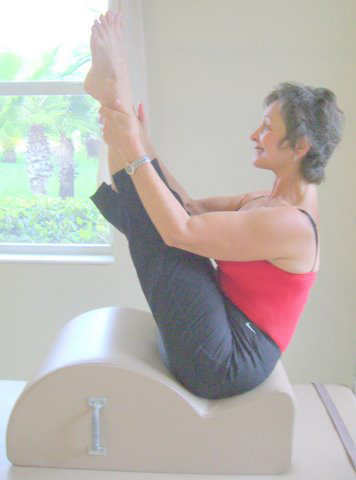 Stretch exercise using pilates spine corrector